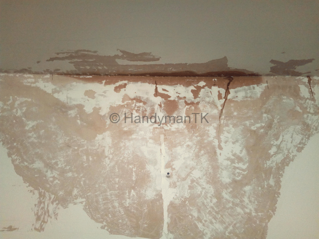 Handyman TK exposed leak in living room before repairing and repainting