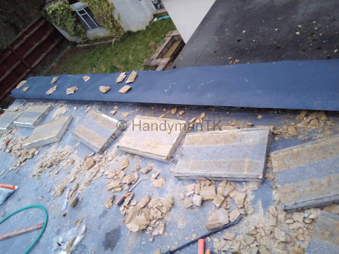 Handyman TK adding dampproof membrane on flat roof to repair leak